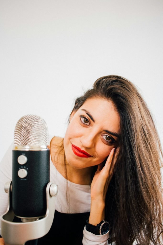 smiling-woman-beside-microphone-s7op9uubsfs